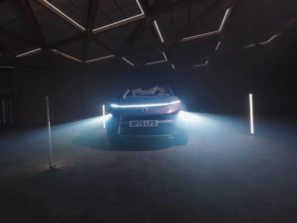 Car lit in a dark studio, filmed with FPV