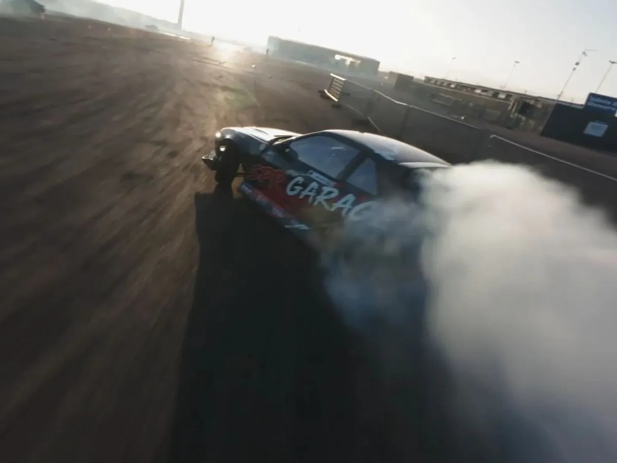 Drift car chased low by an FPV drone