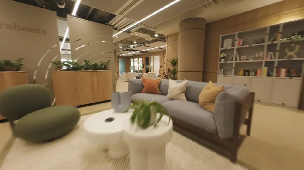 An FPV drone flying low past sofas in a lounge